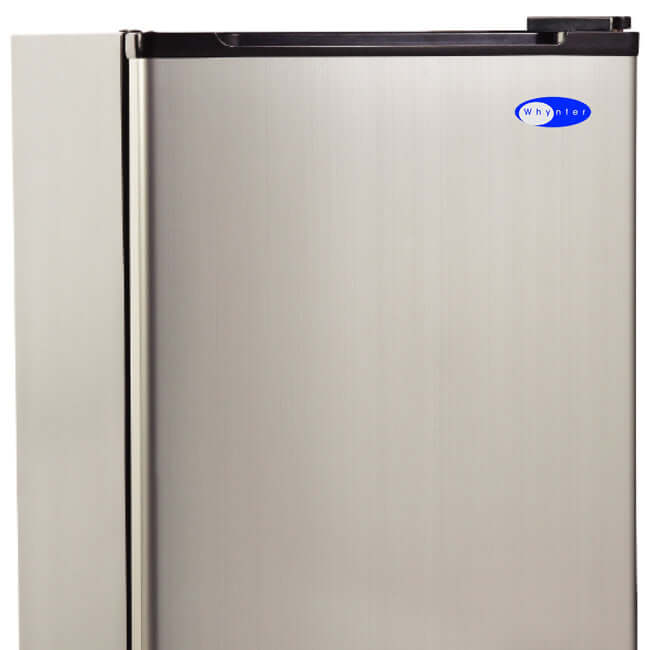 A silver refrigerator with a black handle, perfect for any modern kitchen and bar area. It makes 12 lbs of crescent-shaped ice in 24 hours and can store 6 lbs of ice.