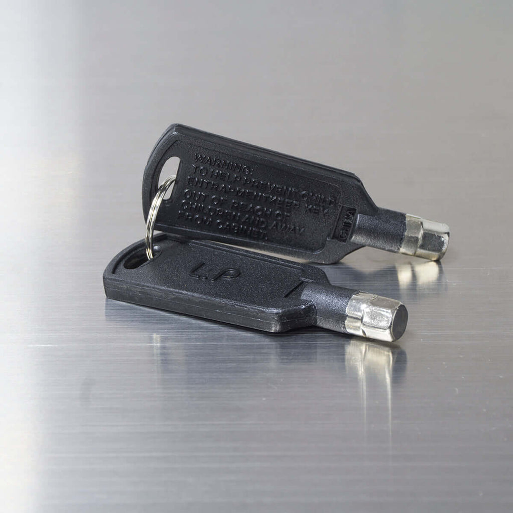 A close-up of a key chain with a keyring attached on a black surface.