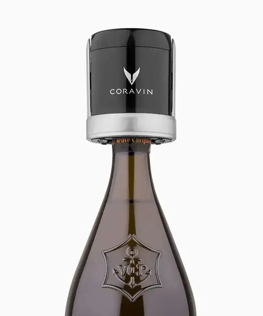 A black-capped bottle of Coravin Sparkling Wine Preservation System, with a close-up view.