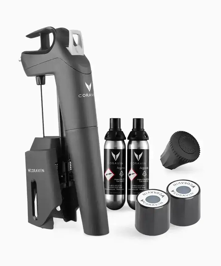 A black device with bottles and a black can with white text and a logo, part of the Coravin Timeless Three+ Wine Preservation System.