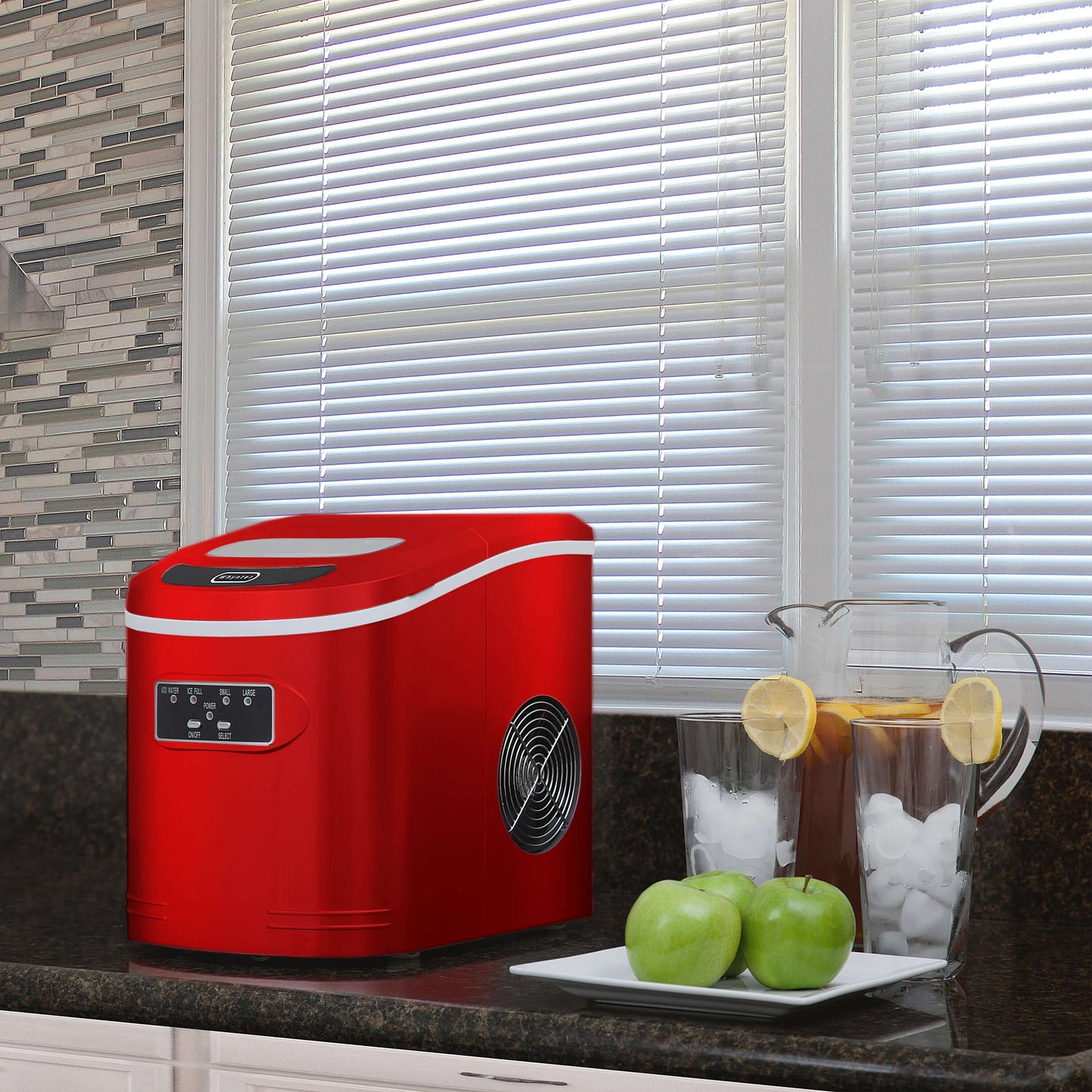 A compact red ice maker with buttons and a fan, capable of producing up to 27 pounds of ice per day. No plumbing required.