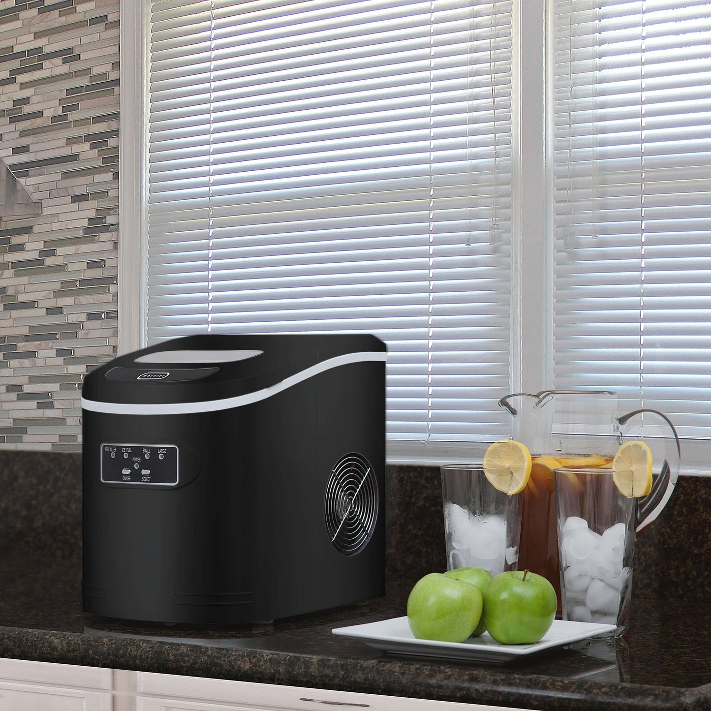 A compact portable ice maker with buttons and a fan, capable of producing up to 27 pounds of bullet-shaped ice cubes per day. No plumbing required.
