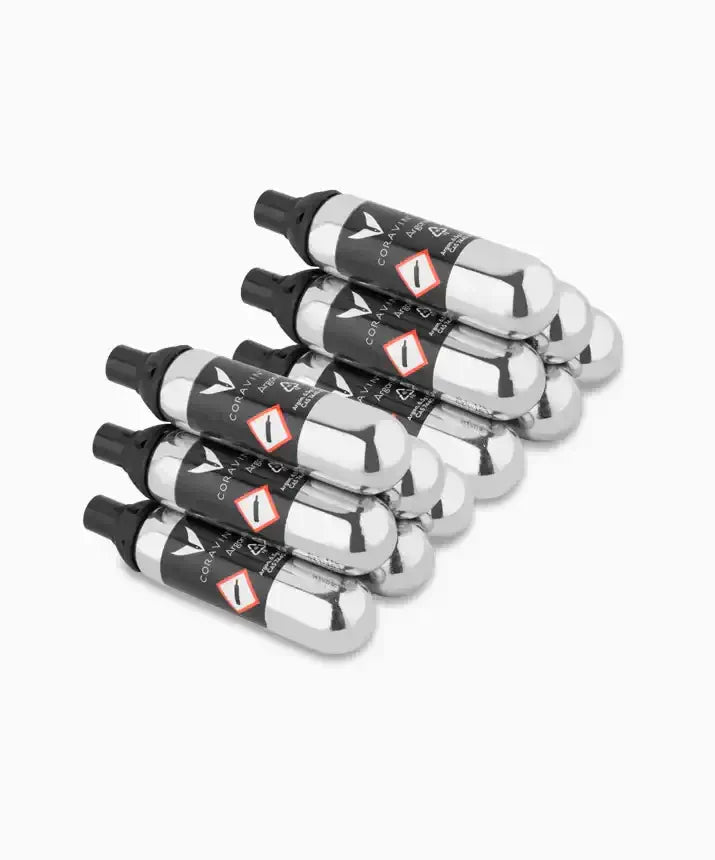 Coravin Pure™ Argon Capsules for Timeless and Pivot™ Wine Preservation Systems - Group of silver objects, stack of packages and tubes, black and silver aerosol cans, close-up of silver containers, black and white label.