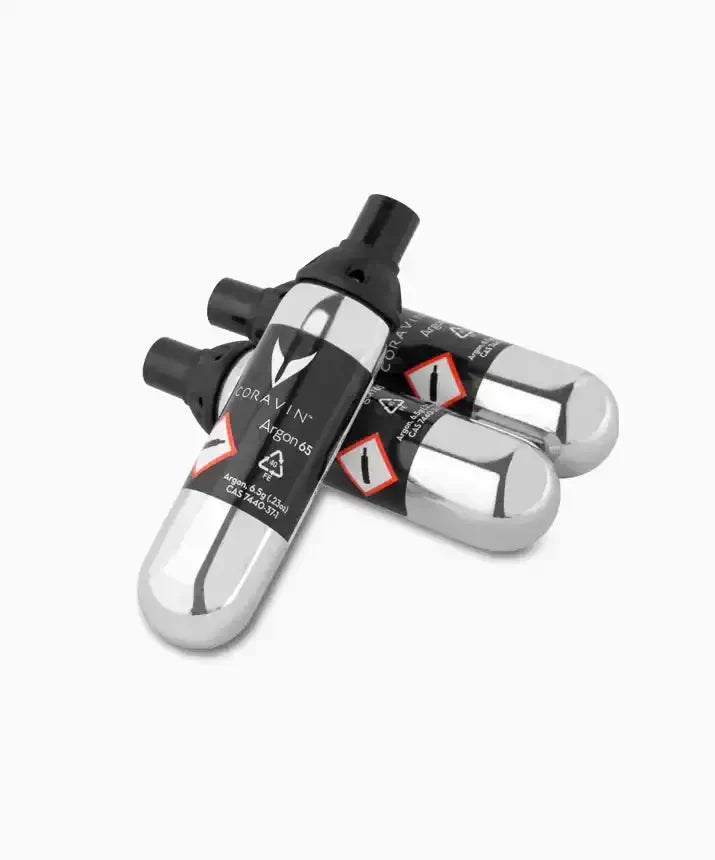 A group of silver cylinders labeled "Coravin Pure™ Argon Capsules" used to power Coravin Timeless and Pivot™ Wine Preservation Systems.