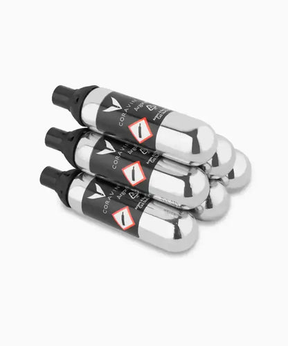 Coravin Pure™ Argon Capsules for Timeless and Pivot™ Wine Preservation Systems, a group of silver objects, including black and white bottles.
