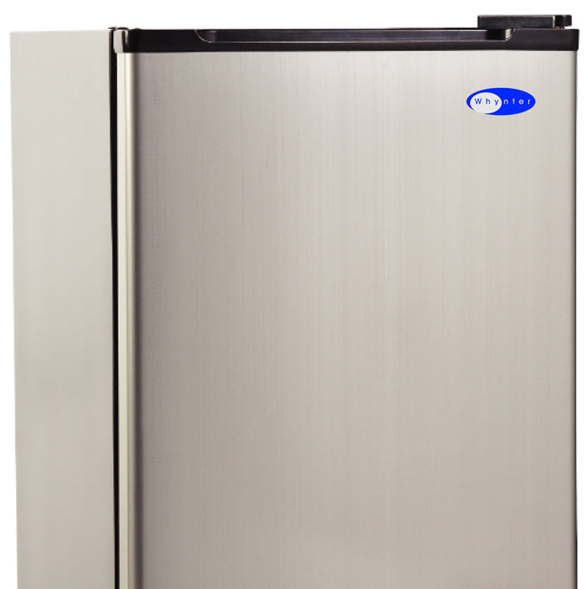 A silver refrigerator with a black handle, perfect for any modern kitchen and bar area. It makes 12 lbs of crescent-shaped ice in 24 hours and can store 6 lbs of ice.