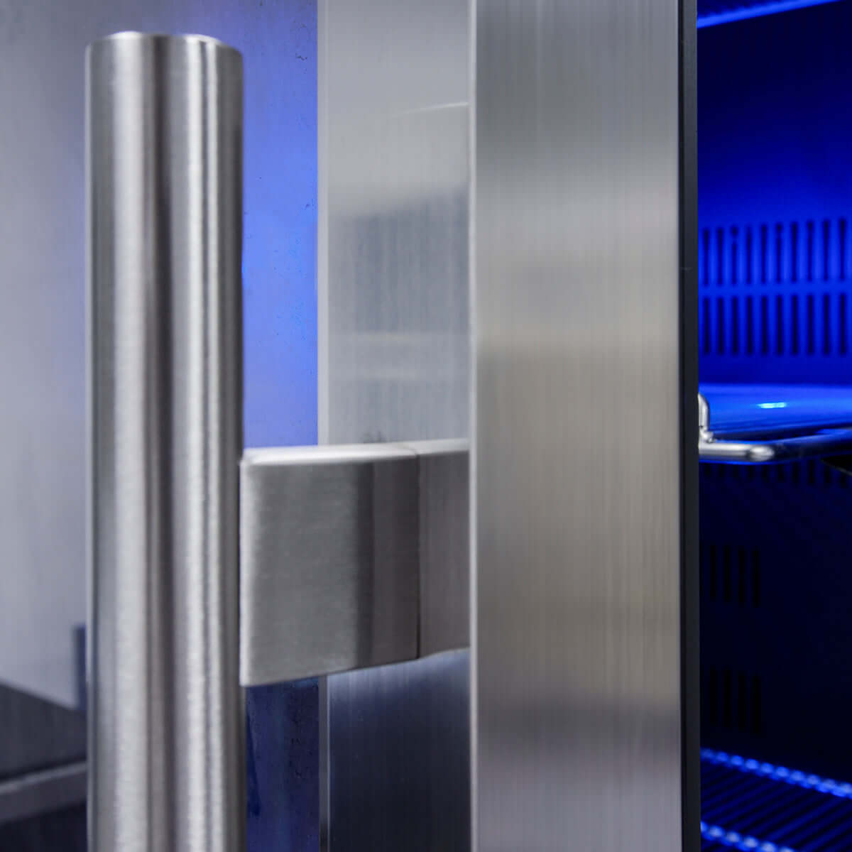 A close-up of the stainless-steel trim and door handle on the Kings Bottle 24" Beer Cooler Fridge Built In Glass Door with Stainless Steel Trim.