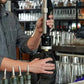 A man holding a black and silver Coravin Sparkling Wine Preservation System.