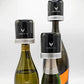 A group of glass bottles with black caps, including a close-up of a bottle and a black and silver seal.