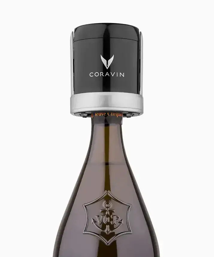 A black-capped bottle of Coravin Sparkling Wine Preservation System, with a close-up view.