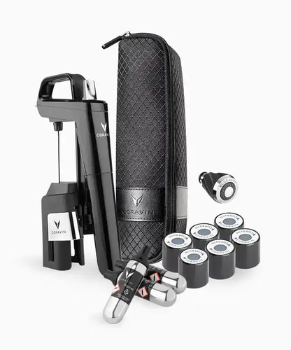 A black device with a case and several small objects, including a black and silver water sprinkler.