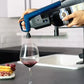 A person pouring wine into a glass using the Coravin Timeless Six+ Wine Preservation System.