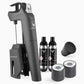 A black device with bottles and a black can with white text and a logo, part of the Coravin Timeless Three+ Wine Preservation System.
