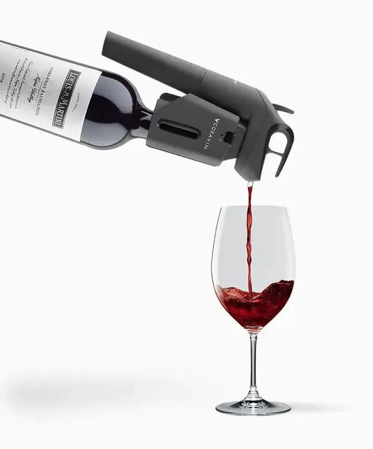 Coravin Timeless Three+ Wine Preservation System pouring wine into a glass with a corkscrew bottle nearby.