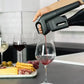 A person pouring wine into a glass using the Coravin Timeless Three+ Wine Preservation System.