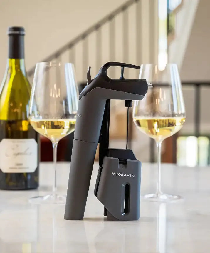 Coravin Timeless Three SL Wine Preservation System: A wine bottle and glass of wine, along with a device for preserving still wines for weeks, months, or even years.