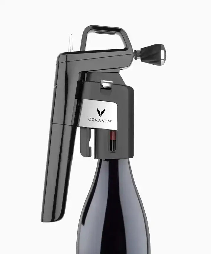 A black Coravin Timeless Aerator attached to a Coravin Timeless Wine Preservation System, enhancing the taste of wine.