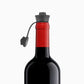 A glass bottle of wine with a cork stopper, surrounded by six Pivot™ Stoppers for wine preservation.