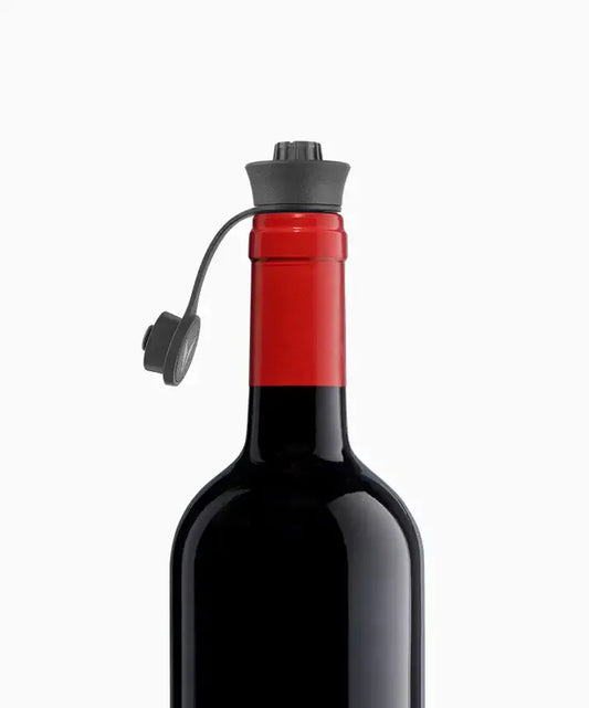 A glass bottle of wine with a cork stopper, surrounded by six Pivot™ Stoppers for wine preservation.