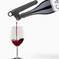 Coravin Pivot™+ Wine Preservation System: A black device pouring wine into a glass, preserving flavor and aroma for up to 4 weeks.