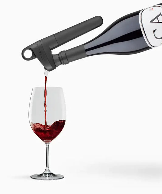 Coravin Pivot™+ Wine Preservation System: A black device pouring wine into a glass, preserving flavor and aroma for up to 4 weeks.