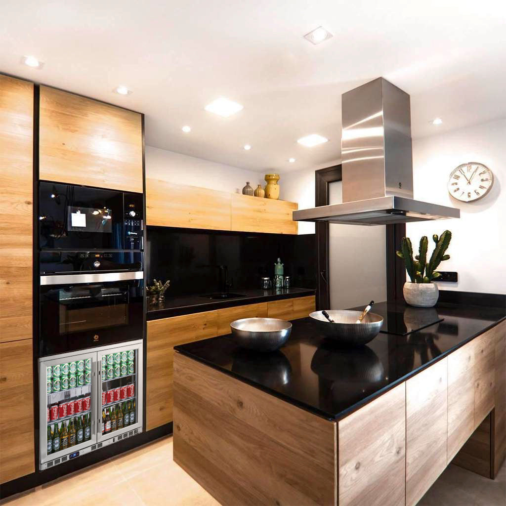 A black countertop kitchen with a stove, clock, cactus, and bowls on it, showcasing the Kings Bottle 36" Heating Glass 2 Door Built In Beverage Fridge.