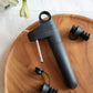 Coravin Pivot™ Stoppers 6 Pack - A black bottle opener on a wooden plate, compatible with Coravin Pivot™ Systems.
