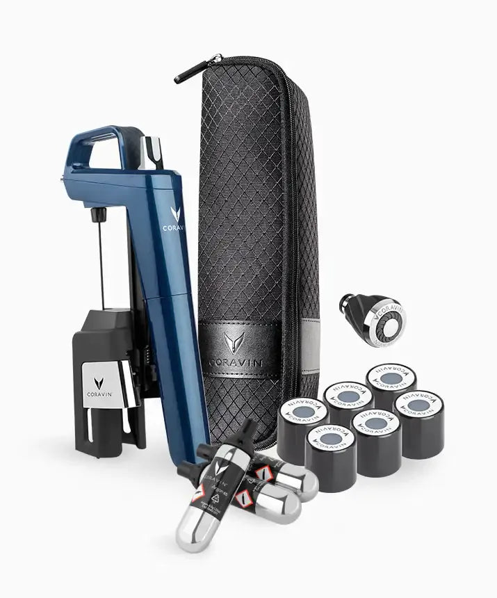 Coravin Timeless Six+ Wine Preservation System: A blue and silver device with a case, small round objects, a coffee cup, and a black tie.